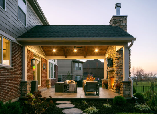 covered porch with fireplace stone